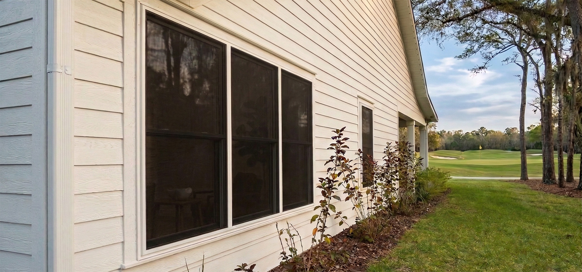 Fortress Screens stainless steel mesh installed on residential windows protecting against golf ball damage