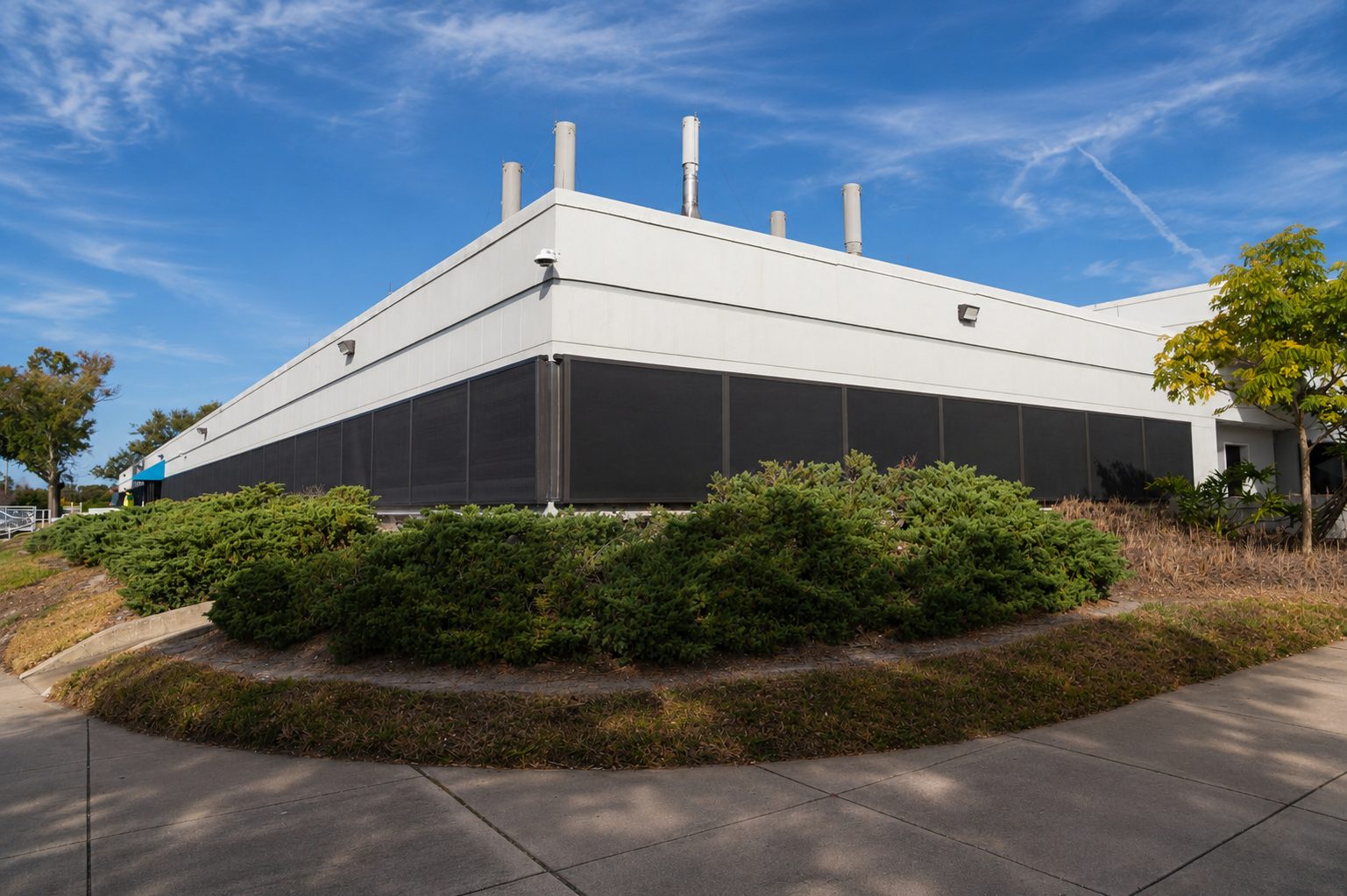 Corner of commercial medical facility windows fitted with hurricane-rated stainless steel screens