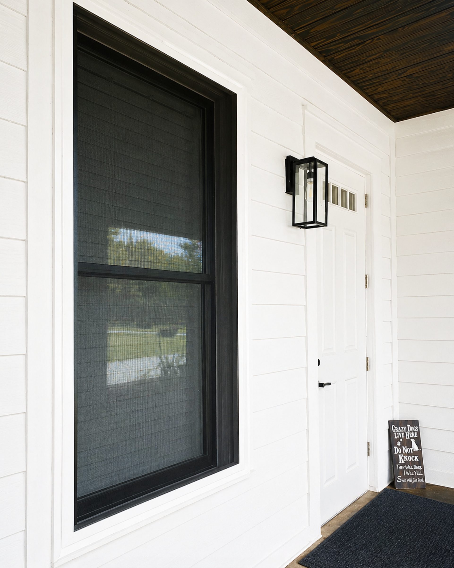 Close view of a single residential window protected by a Fortress stainless steel screen
