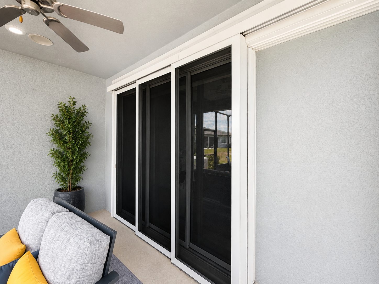 Sliding glass doors on a Florida home protected by Fortress stainless steel screens