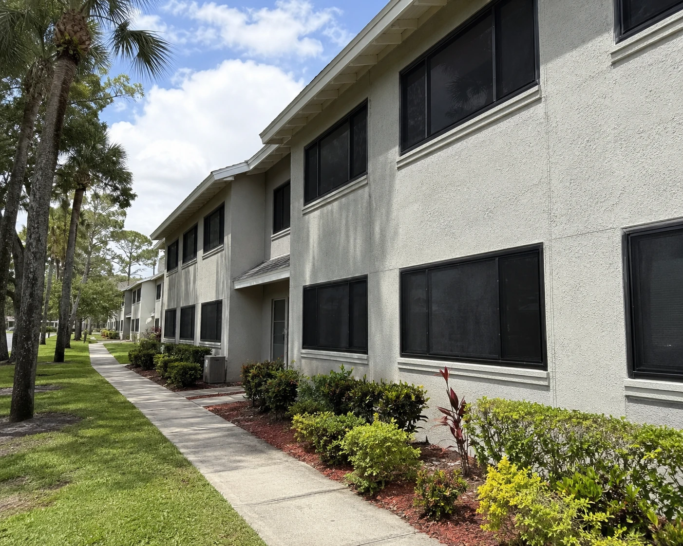 Florida housing authority building with multiple windows fitted with dark Fortress protective screens