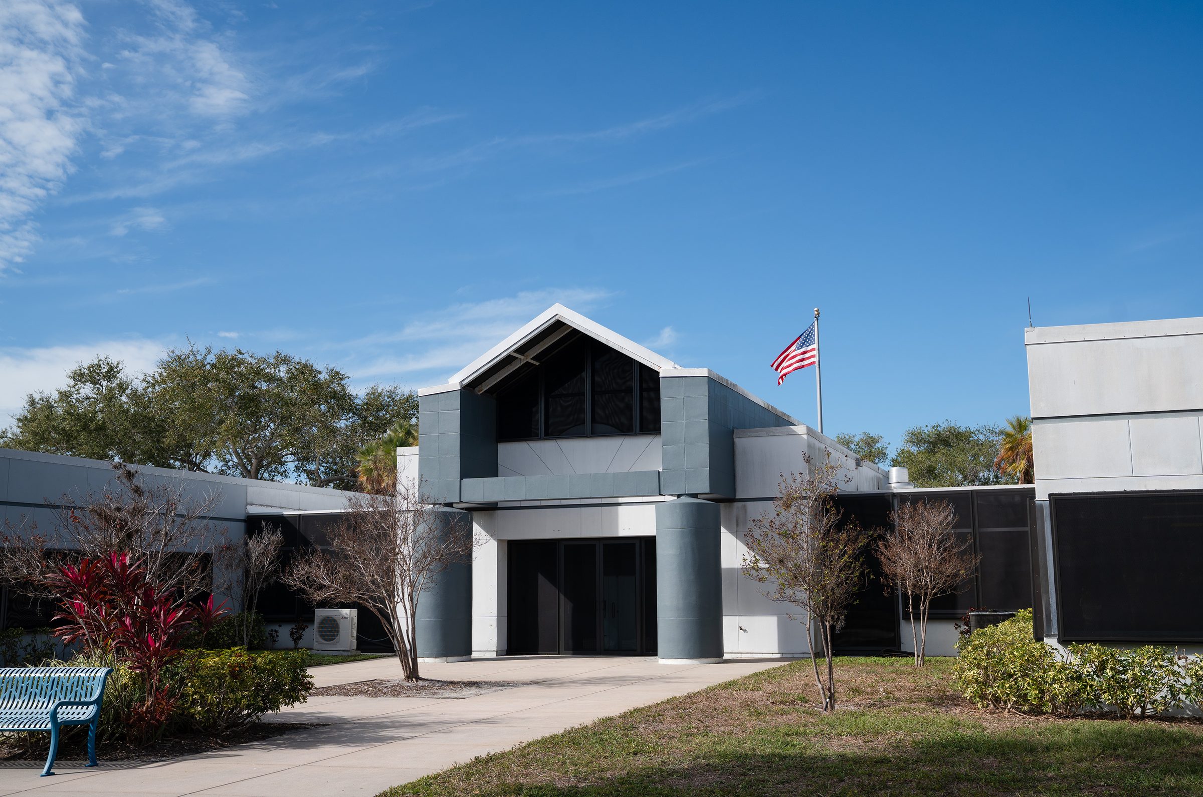 Commercial medical facility with dark Fortress screens installed across windows surrounding the main entrance