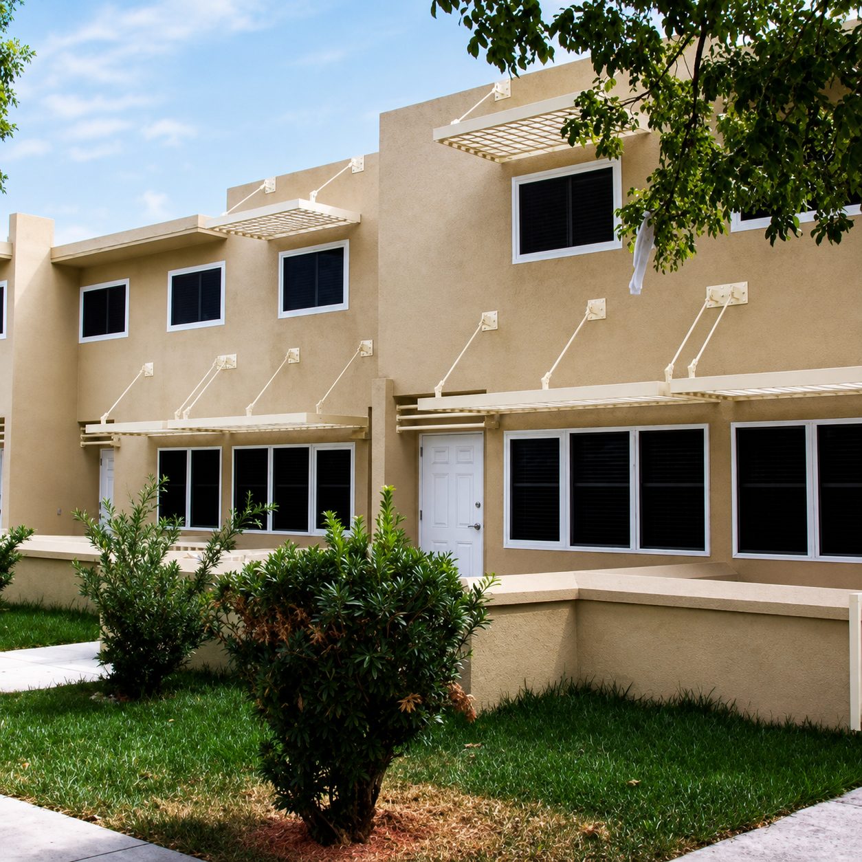 Two-story apartment building with dark Fortress screens installed across windows and doors